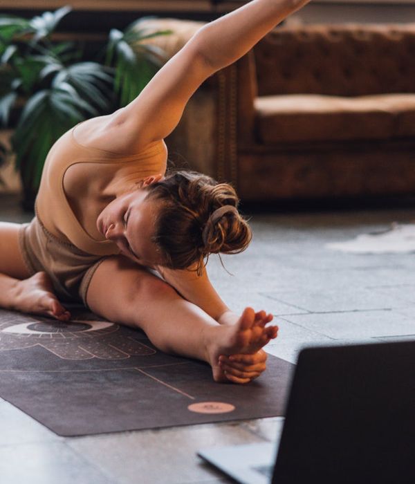 Person stretching on a yoga mat showing flexibility.